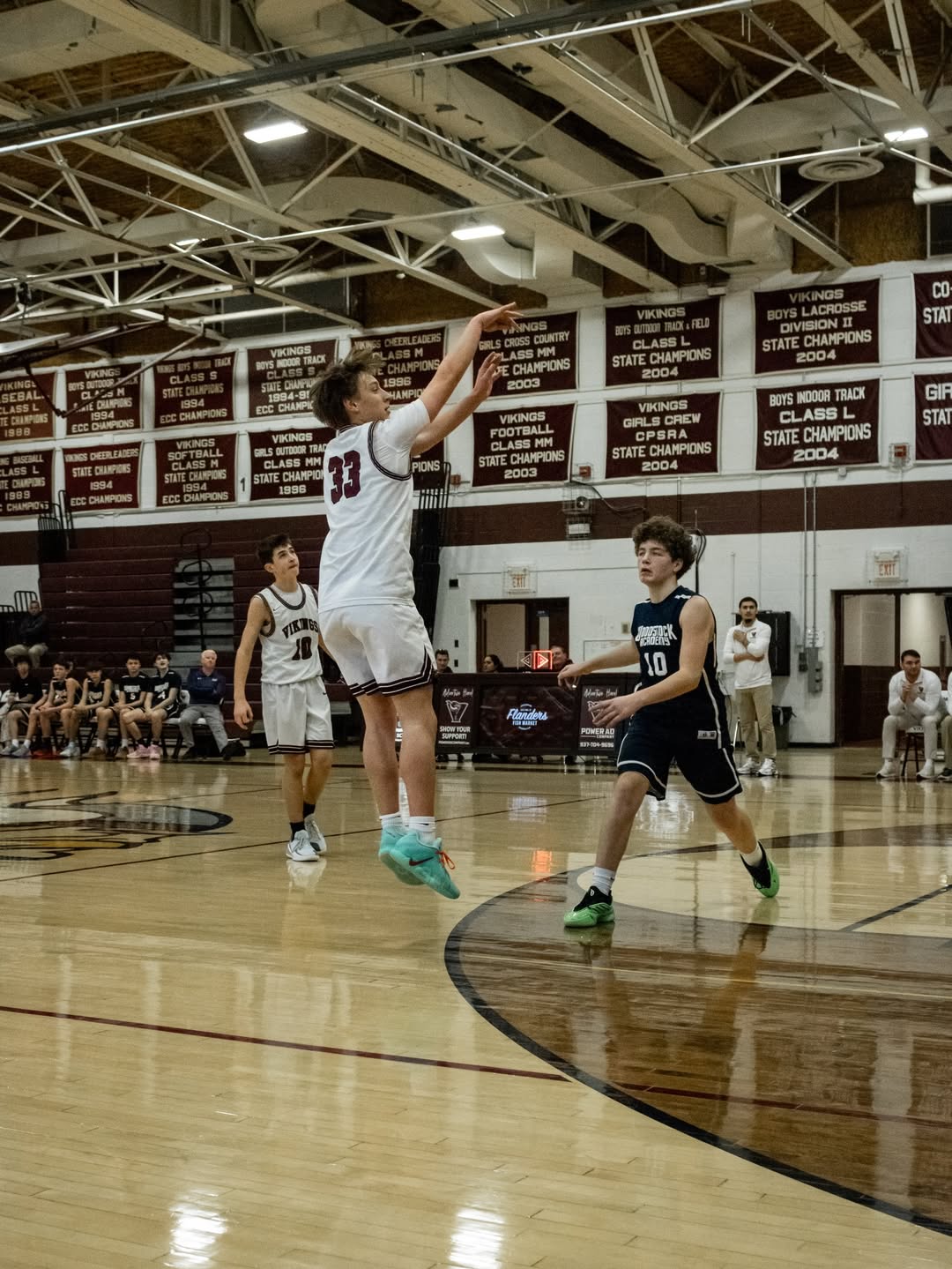 East Lyme number 33 holding his follow-through after a jump shot