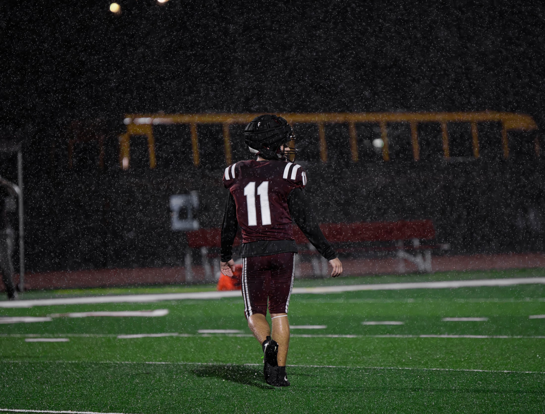 East Lyme number 11 walking downfield through the rain