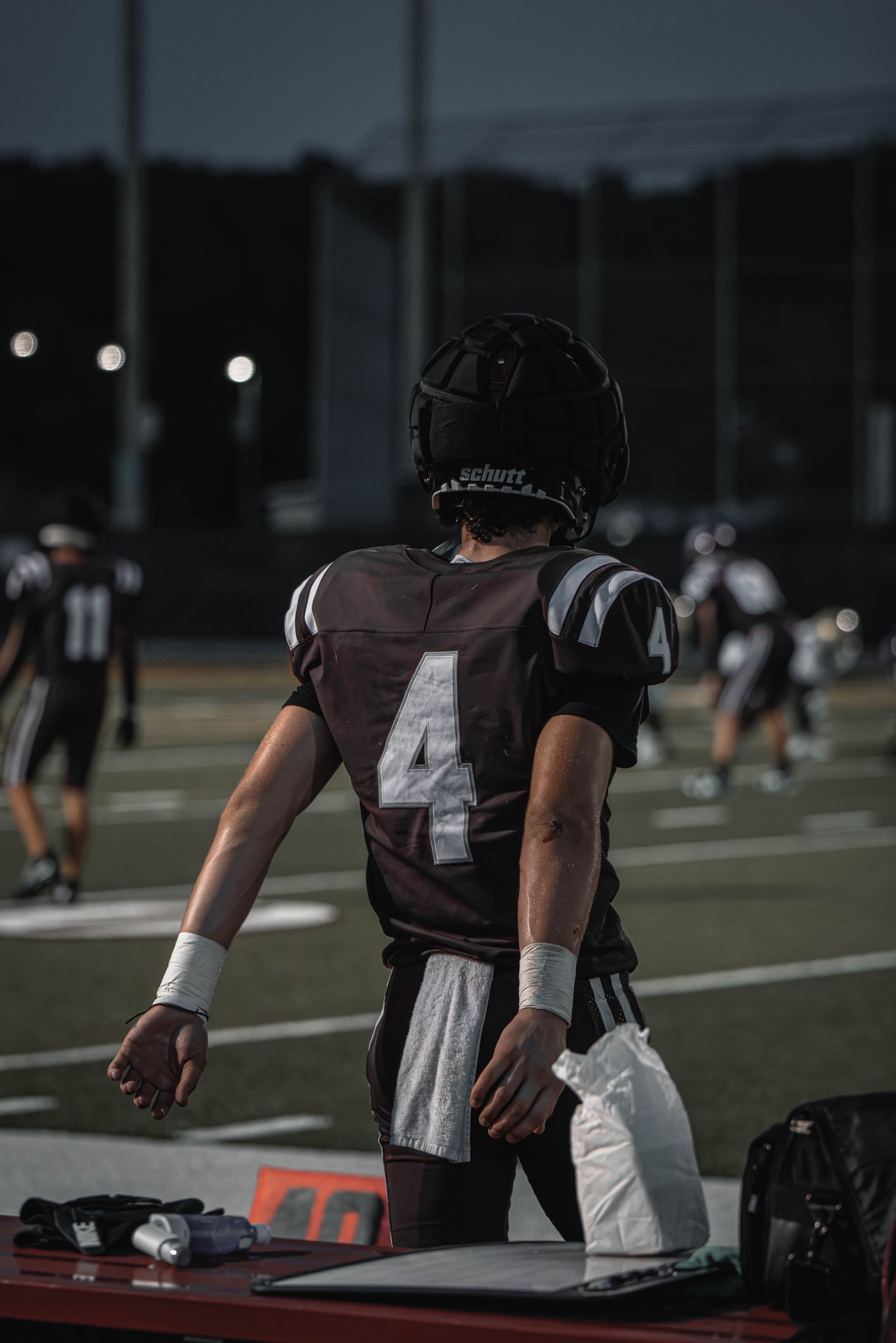 East Lyme number 4 standing near the sideline after a football play