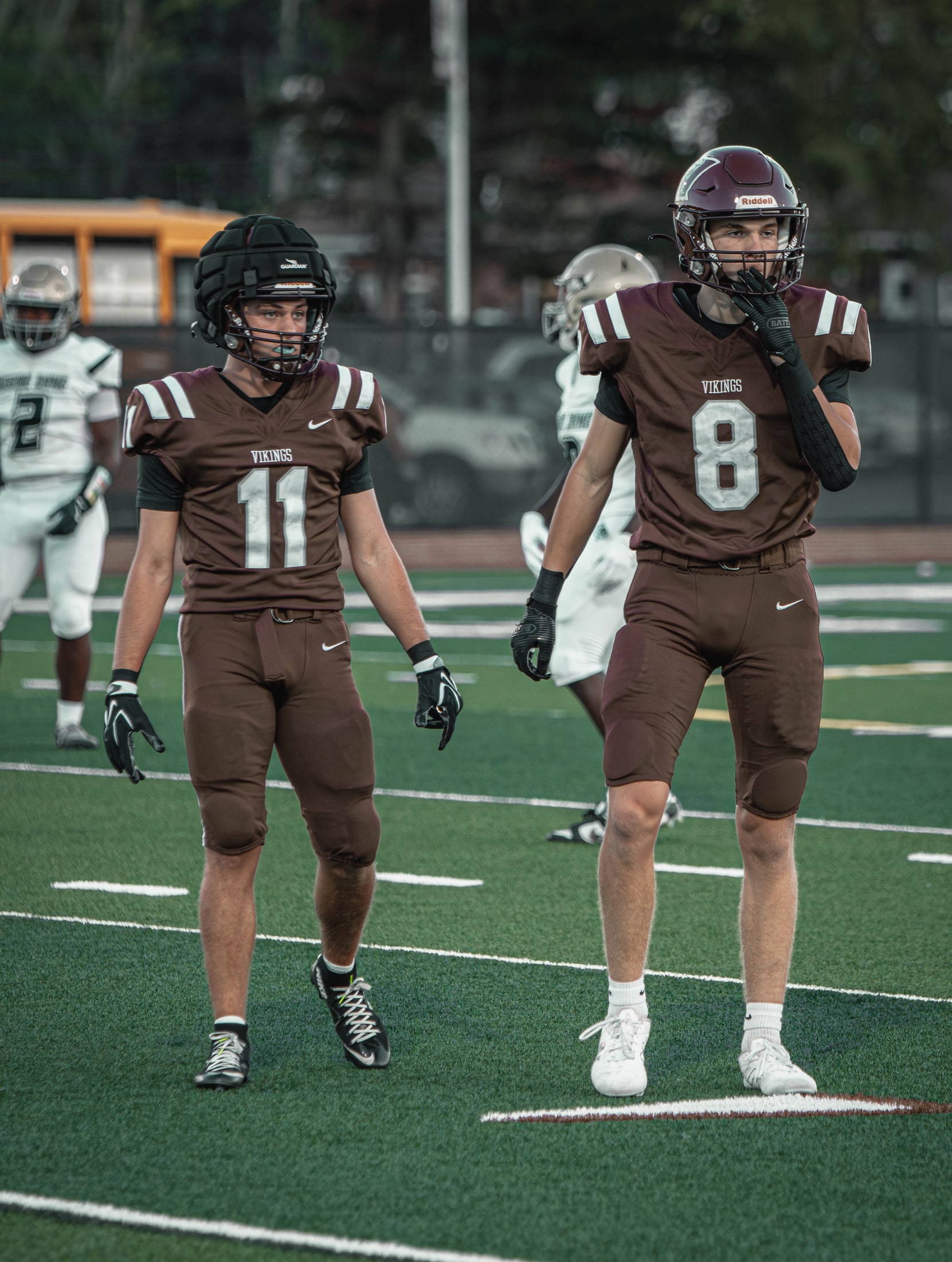 East Lyme numbers 11 and 8 walking together between plays