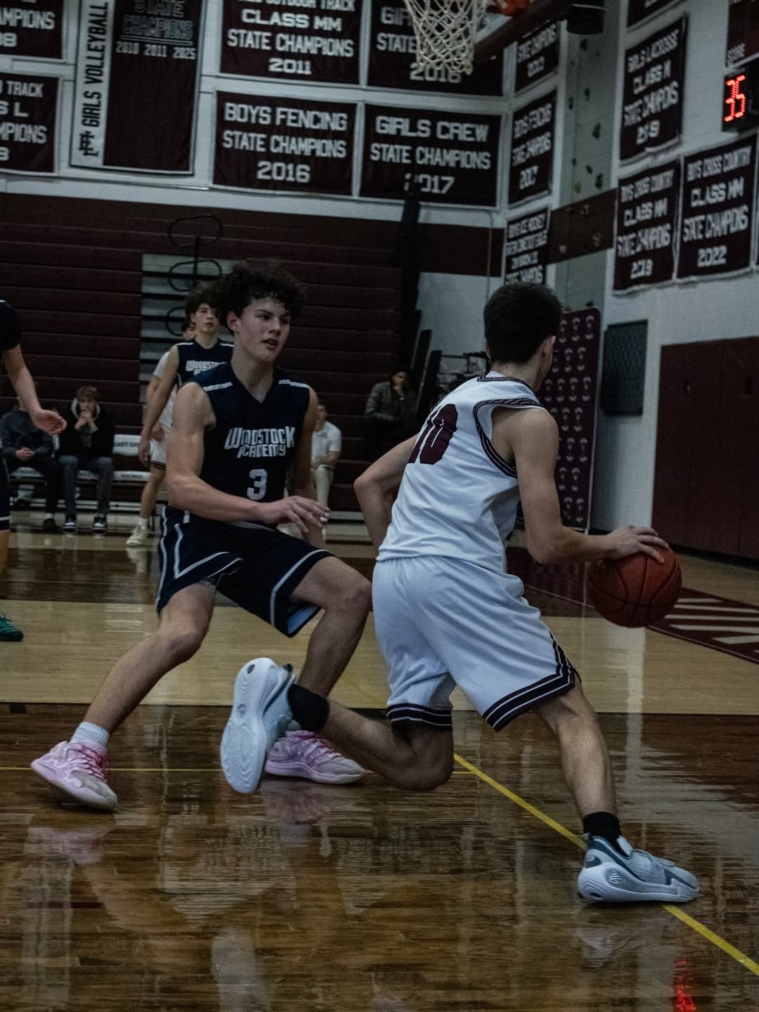 East Lyme player driving hard around a defender toward the basket