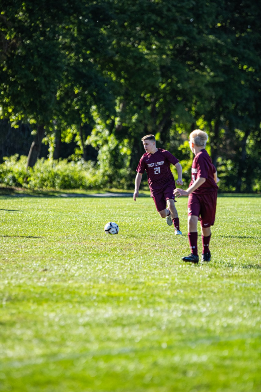 East Lyme number 21 advancing toward the ball in open field