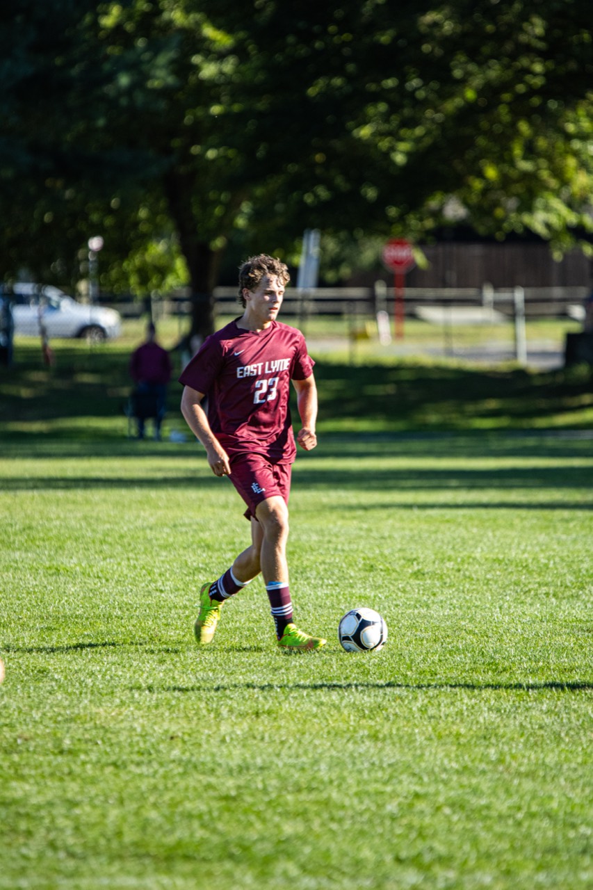 East Lyme number 23 carrying the ball through midfield