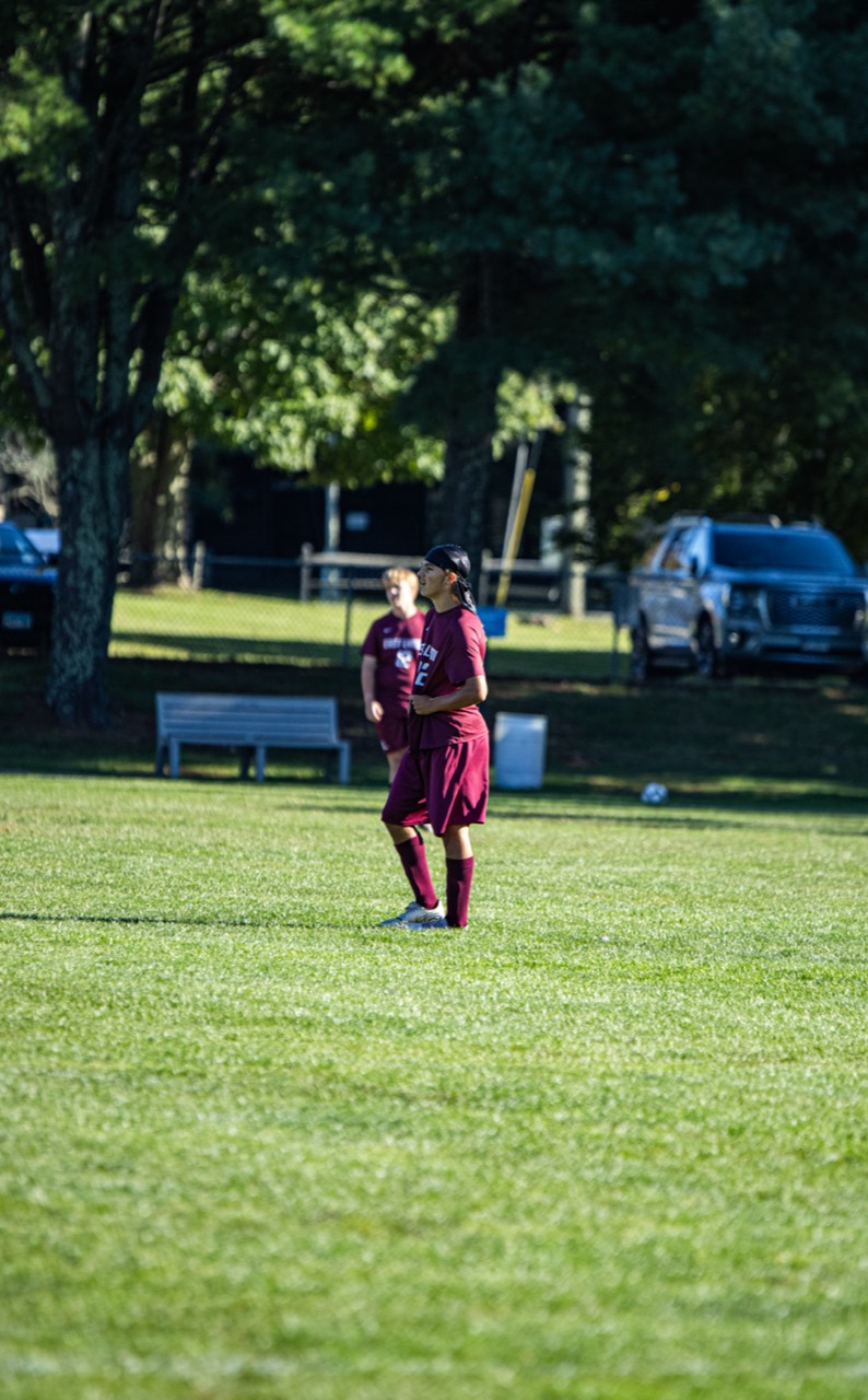 East Lyme number 22 watching play develop from midfield