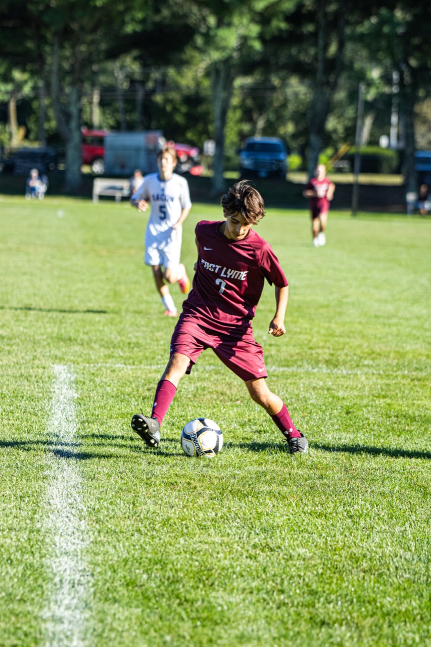 East Lyme number 7 controlling the ball near the touchline